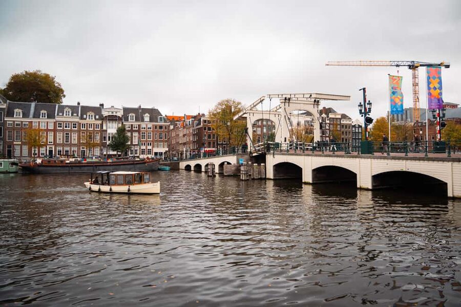 Amsterdam Canal Boat Tour with Live Guide - Stepping onto a heated open-roof boat (and staying comfortable)