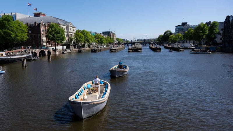 Amsterdam: Canal Cruise in Open Boat with Drink Option - Entering Amsterdam From the Water, Without the Noise