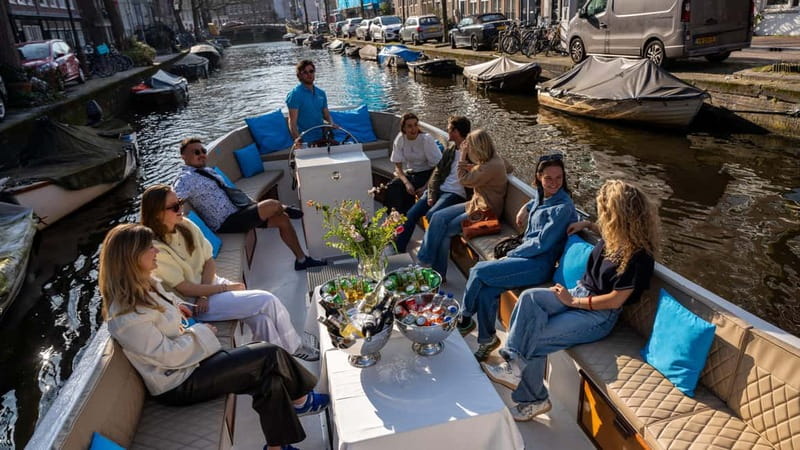 Amsterdam: Canal Cruise in Open Boat with Drink Option - Drink Option: Turning a Scenic Ride Into a Small Treat