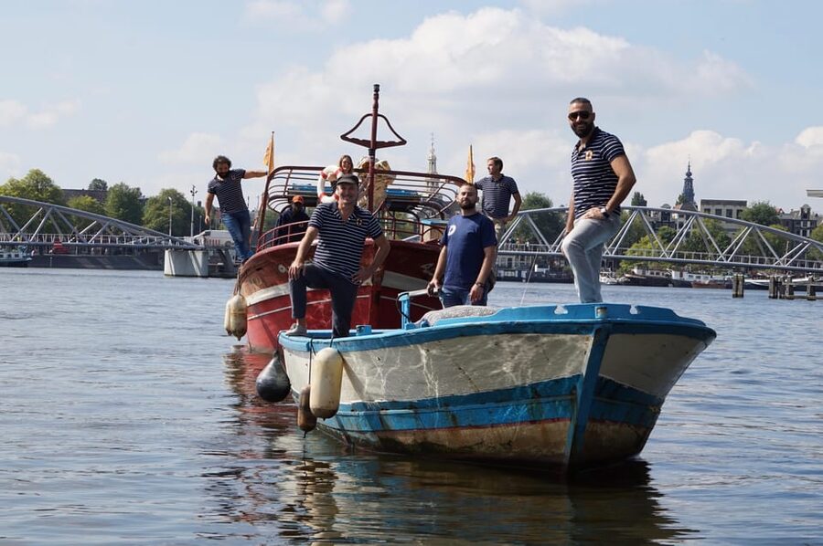 Amsterdam: Canal Cruise on a Wooden Refugee Boat - Practical Tips for an Open-Boat Ride in Amsterdam Weather