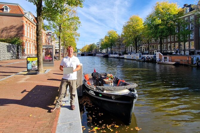 Amsterdam Canal Tour by Open Boat – 90 min Small Group Experience - Kolksluis, medieval locks, and old warehouses that still feel alive