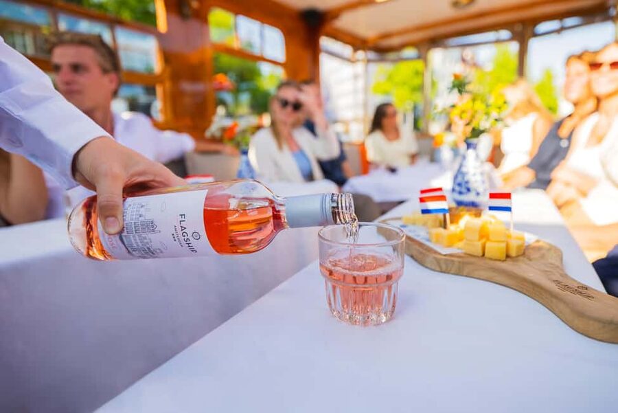 Amsterdam: Classic Saloon Boat Cruise with Cheese & Wine - Entering a classic Amsterdam saloon cruise, on a fully electric boat
