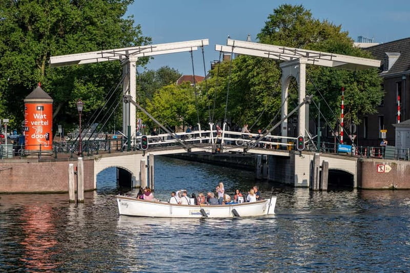 Amsterdam: Guided City Highlights Open Boat Canal Cruise - Westerkerk, the Anne Frank House area, and the bridge-and-house details that stick