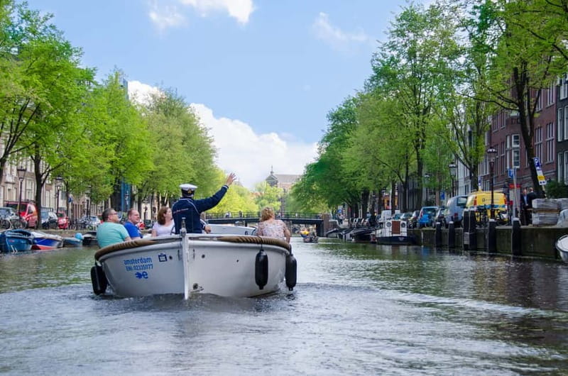 Amsterdam: Guided City Highlights Open Boat Canal Cruise - First passes through the entertainment corridor: Hard Rock Cafe, Holland Casino, and Amsterdam-Centrum