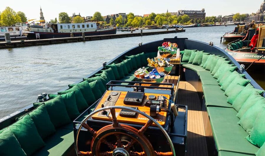 Amsterdam: Guided Open Boat Cruise Unlimited Drinks Option - Westward toward iconic towers and the Anne Frank House area