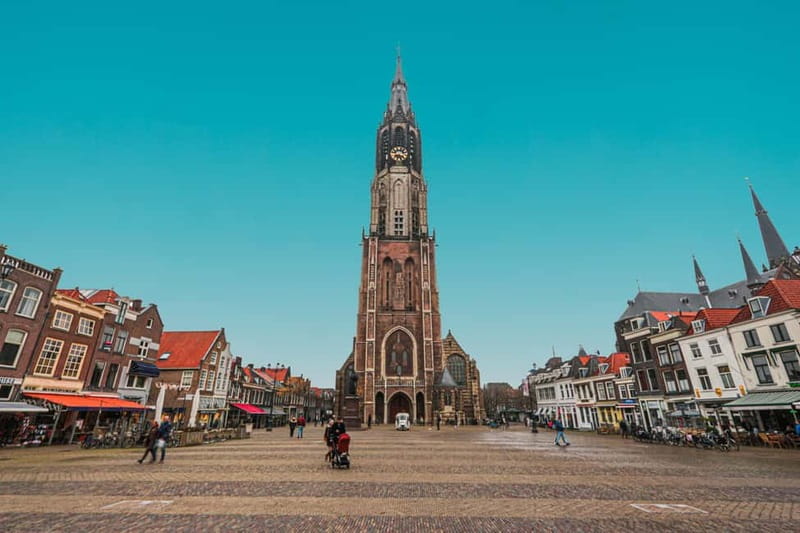 Amsterdam: Kinderdijk, Euromast, Delft and Den Haag Day Tour - Delft on Foot: Medieval Towers, Canals, and Gables Without the Crush