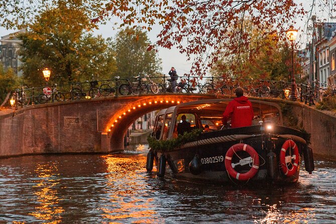 Amsterdam: Light Festival Open Boat - Unl. Drinks Option - The 1516 watchtower, silly Jake, and the fun of clock-tales