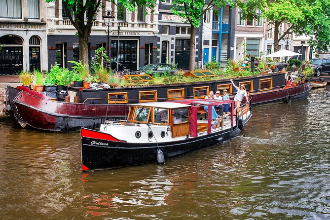 Amsterdam Small-Group Canal Cruise With Dutch Snacks and Drink - Flea market energy and historic maritime atmosphere