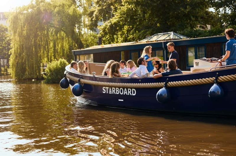Amsterdam: Spanish Guided Open Boat Cruise with Bar Onboard - Electric Open Boat Views: Skinny Bridge, Canal Belt, and the Famous Names