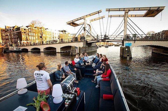 Amsterdam Sunset Canal Cruise with Live Guide and Open Bar - Church towers, an ice bar, and the city widening out