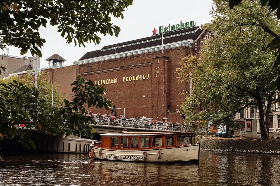 Amsterdam: The Heineken Flagship Canal Cruise - Rijksmuseum departure point, crew colors, and the one tricky boarding step
