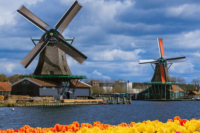 Amsterdam: Windmills, Cheese and Volendam Tour with Video Guide - Zaanse Schans: operating windmills, canalside walks, and clog-making