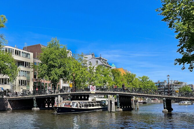 Discover Amsterdam: Luxury Canal Cruise with a Local Skipper - The ride setup: tables, panoramic views, and a toilet on board