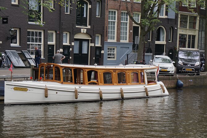 Eating Amsterdam: Food Tour & Canals Cruise - WWII context near a historical site, then bitterballen and jenever at Café Dialoog