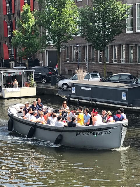 Visit Amsterdam by Boat with a French Guide (french) - Small electric boat and French guide, why this style works